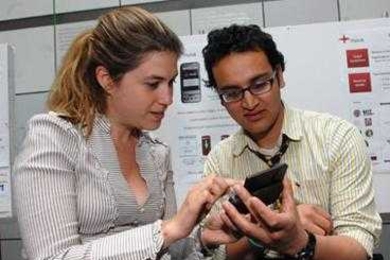 Harvard graduate students Ankush Sharma, right, and Alexis Geancotes, left, (who also study at MIT) represent the MoCa team, which developed mobile diagnostics to improve health care in the developing world.