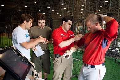 A player at the Boston Red Sox preseason training camp is wired with sensors developed by the MIT Media Lab, which gauge the forces he exerts when he swings the bat.