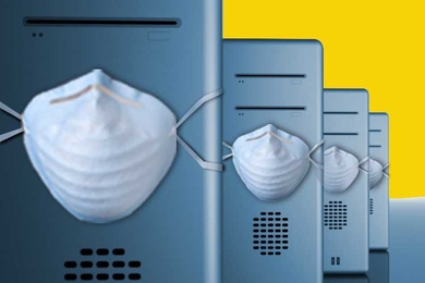 Four computer PCs sit in a line, each with a mask wrapped around center