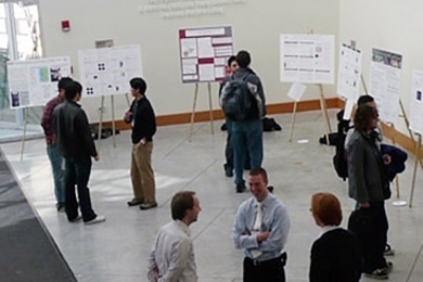 Presenters and visitors at the NSE Graduate Research Expo poster session.