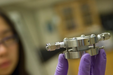 Doctoral student Yi-Chun Lu holds an experimental lithium-air battery that was used for testing at MIT.