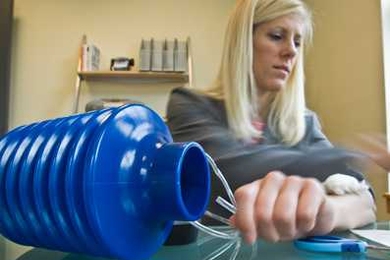 Danielle Zurovcik SM '07 demonstrates how to use the negative pressure pump to seal an arm wound.