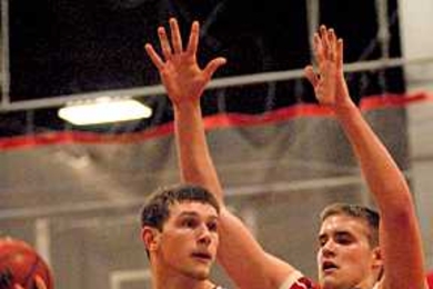 Freshman forward Will Tashman looks to pass against Clark University.
