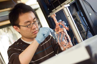 Graduate student Ye Tao adjusts the magnetic force resonance microscope that he and Assistant Professor Christian Degen are building at MIT.  