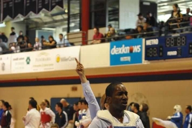 Graduate student Chris Williams is declared the gold-medal winner in the men's blue belt heavyweight sparring division.