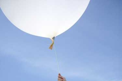 Stewart Long (right) prepares to launch a balloon-mounted camera from the Chandeleur Islands in Louisiana.