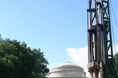 From left to right, Peter Flemings, Mark Andrews and Kristopher Darnell of the University of Texas at Austin; Stephen Ramsdell and Orrin Cone, drillers with New England Boring; and John Germaine pose on Killian Court with a drilling rig that helped the researchers gather data on an experimental probe that measures soil pore pressure.
