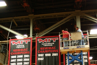 Workers installed the new banners in Rockwell Cage, which commemorate MIT’s conference championships.