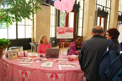 Karen Najjar, left, and Lisa Owens of MIT Medical hand out information about mammograms and breast cancer detection to passers-by in Lobby 10.