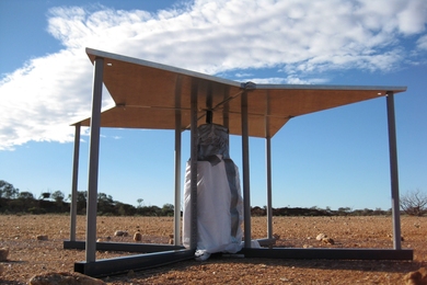 Close up of the EDGES antenna. The four panels are made from aluminum sheet metal and supported by PVC legs. The white bag under the antenna encloses analog amplifiers and calibration circuits.