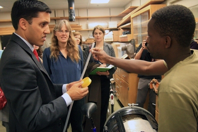Dr. Rajiv Shah, head of USAID, visits with D-Lab Founder Amy Smith, center, and students in D-Lab.