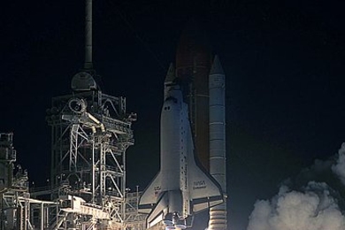 The space shuttle lifts off in December, 1993, with Hoffman aboard, for the first mission to repair the Hubble Space Telescope.