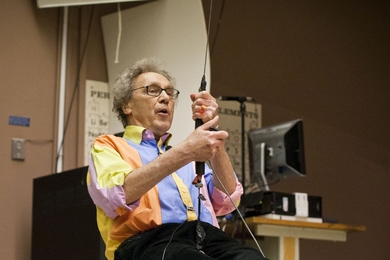 Walter Lewin demonstrates one of his famous lectures, showing that a pendulum’s period remains constant regardless of mass.