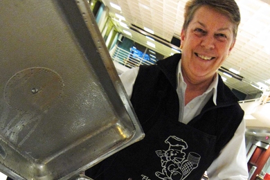 Students take a break during finals week for free breakfast at night during Flapjacks for Finals at the Stratton Student Center on May 15. MIT Police Sergeant Cheryl Vossmer, who founded the event 12 years ago, shows the flapjacks that will power MIT undergraduates through their finals.