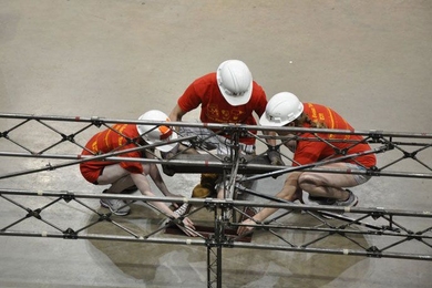 Team members assemble the bridge at the national Student Steel Bridge Competition.
