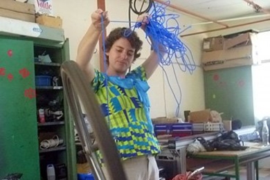 Anna Waldman-Brown demonstrates hands-on science using a bicycle gyroscope at Takorardi Technical Institute.