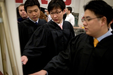 Students in Rockwell Cage determine where they need to go for the procession later in the day.