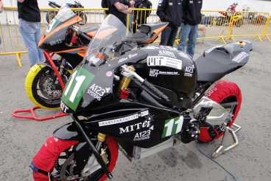 The eSuperbike warms up before a practice round. Team members wrapped the tires to keep them warm, softening the rubber and maximizing tire grip.