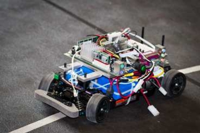 The researchers test their algorithm using a miniature autonomous vehicle traveling along a track that partially overlaps with a second track for a human-controlled vehicle, observing incidences of collision and collision avoidance.