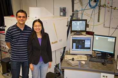 Research Laboratory of Electronics graduate students Vitor Manfrinato and Lin Lee Cheong, with the electron-beam lithography system they used in their experiments.