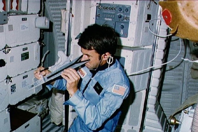 The late William Lenoir '61, SM '62, PhD '65 was the first MIT alumnus to fly on the space shuttle, joining the crew of STS-5 aboard Columbia in 1982. Here Lenoir checks vision using DIOPTER measuring device during that flight.
