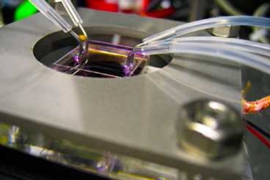 Zinc oxide nanostructures are directly synthesized in parallel microfluidic channels (held by the metal frame) by flowing reactants through the tubing. The microfluidic structure not only creates the device, but also becomes the final packaged functional LED device itself.