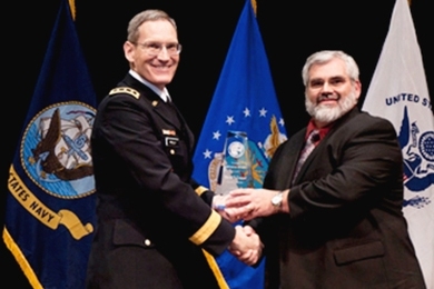 Lieutenant General Patrick O'Reilly, MDA director, left, presents the Pinnacle Award trophy to David Conrad at the annual MDA awards ceremony.