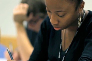 A student writes while at desk