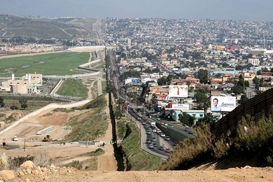 A small fence separates densely populated Tijuana, Mexico, right, from the United States in the Border Patrol's San Diego Sector.