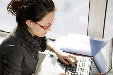 Woman typing on a laptop