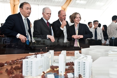 The groundbreaking participants look at a scale model of the SUTD campus.
