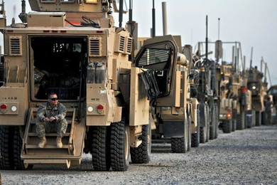 U.S. Army soldier with the 82nd Airborne Division surveys the area while crossing the Khabari border from Iraq into Kuwait on Dec. 9.