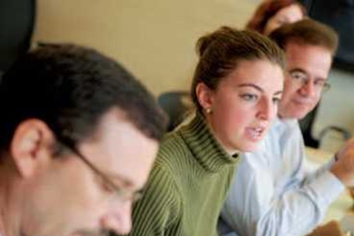Junior Alix de Monts, center, chair of the Undergraduate Association (UA) Sustainability Committee and undergraduate representative on the Campus Energy Task Force, provides an update on the UA's spring 2011 exchange of 1,000 compact-fluorescent light bulbs for incandescent bulbs in student dorms.