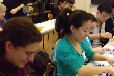 Volunteers Betsy Soukup and Chelsea He work on assembling LEGO amino acid models.