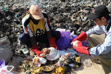Graduate student Kevin Kung, right, sorted through trash with a waste collector outside of Nairobi, Kenya, over Independent Activities Period (IAP). Kung’s IDEAS Global Challenge team, Takachar, is developing efficient ways to produce charcoal from common household organic waste, such as maize husks and other food products.