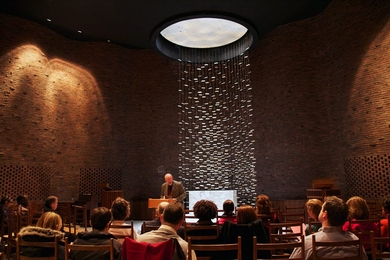 Chaplain to the Institute Robert Randolph, center, speaks to dozens of Tuesdays in the Chapel attendees on Feb. 14.