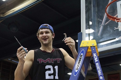 Junior Will Tashman takes his turn cutting down the net after the game.
