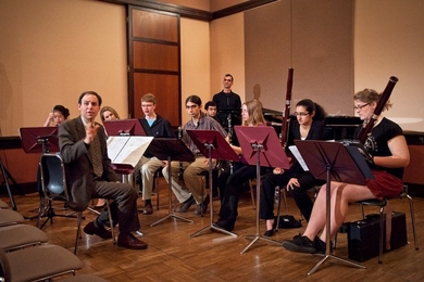 Frederick Harris, Jr., music director of the MIT Wind Ensemble with members of the MIT Wind Ensemble and visiting artist Jamshied Sharifi