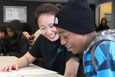 Jane He tutoring Emmanuel DeBarros in critical reading during the Sunday Sessions of Amphibious Achievement.