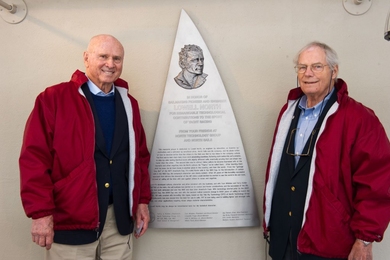 Lowell North and Terry Kohler '62 in front of the relief sculpture overlooking the new dock system.
