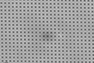 Seen from above, a sheet of silicon has been textured with an array of tiny inverted-pyramid shapes, so small that they correspond to the wavelengths of light and can efficiently trap light waves.