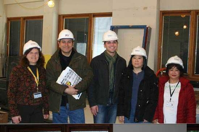 Before and after: Clinical laboratory staff donned hard hats to visit the lab during renovations (top), and pose in the same spot after moving back into the newly renovated space almost a year later.