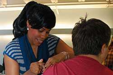 Nicole Napier, M.S.M., B.S.N., R.N., nurse coordinator in MIT Medical's OB/Gyn Service, gives a shot.