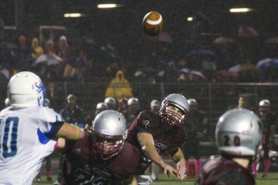 Sophomore quarterback Peter Williams lofts a pass to sophomore running back/wide receiver Brad Goldsberry (#20). In the second half, Goldsberry set up the winning score with a 61-yard kickoff return.