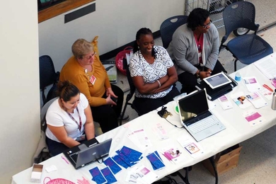 MIT Medical clinicians and staff members hold an interactive educational event in the E25 atrium.