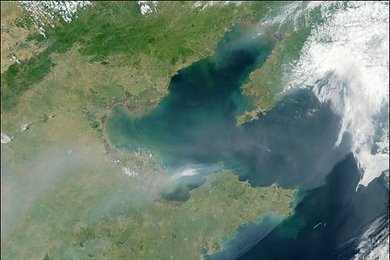 Satellite image of a thick plume of aerosol pollution over eastern China, extending eastward over Bo Hai Bay and Korea Bay.