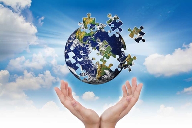 Earth as a puzzle with pieces flying into the sky, while a pair of human hands are underneath