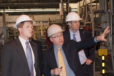 Earl Marmar, head of the Alcator project, introduces Kennedy to MIT's tokamak, accompanied by David Belluck of Riverside Partners.
