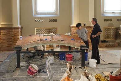 Civil engineering senior Nicky Soane works on the Guastavino vault replica at the Boston Public Library as mason Steve Bolognese looks on.