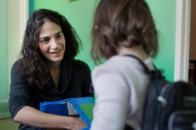 Laura Schulz, primary investigator in the Early Childhood Cognition Lab in the Department of Brain and Cognitive Sciences, works with Madeline Wilson, who is wearing a backpack outfitted with a microphone that records her speech.
